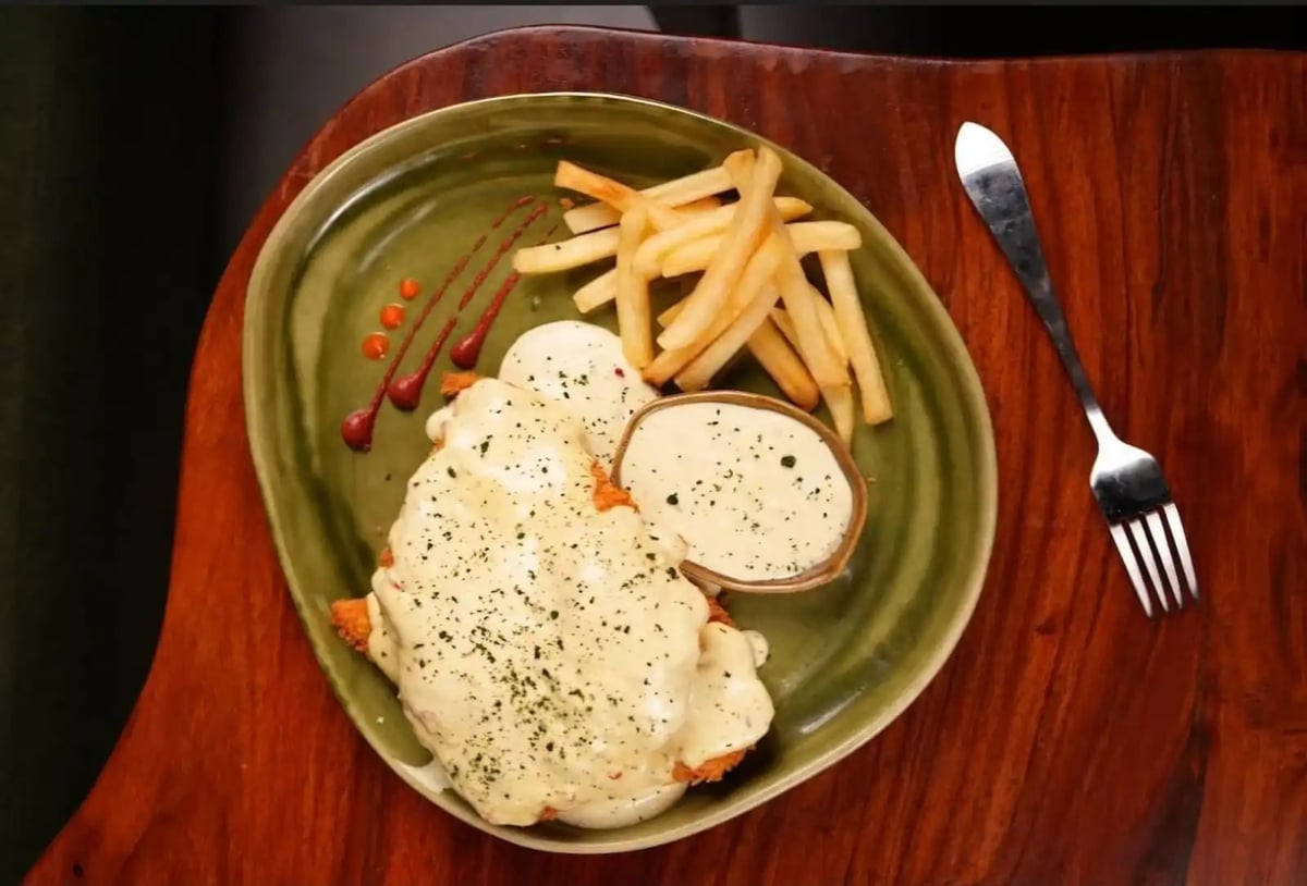 Chicken parmesan with creamy white sauce and fries